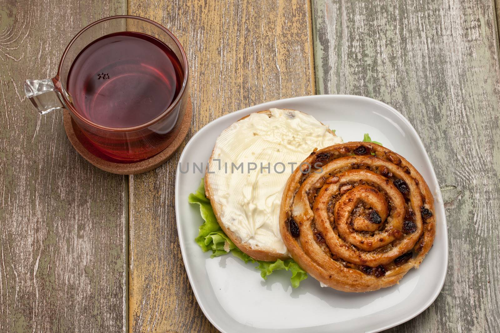 Cup and and pastry with chocolate on a wooden desk