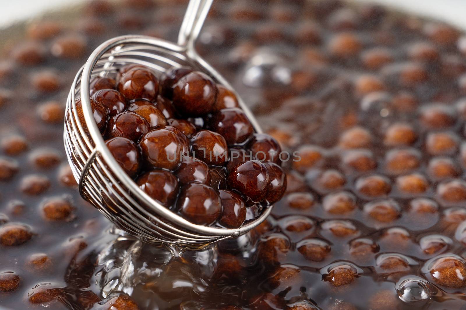 Cooking, boiling brown sugar flavor tapioca pearl balls, ingredient of bubble tea, preparing food and drink, close up, recipe cookbook steps design concept.