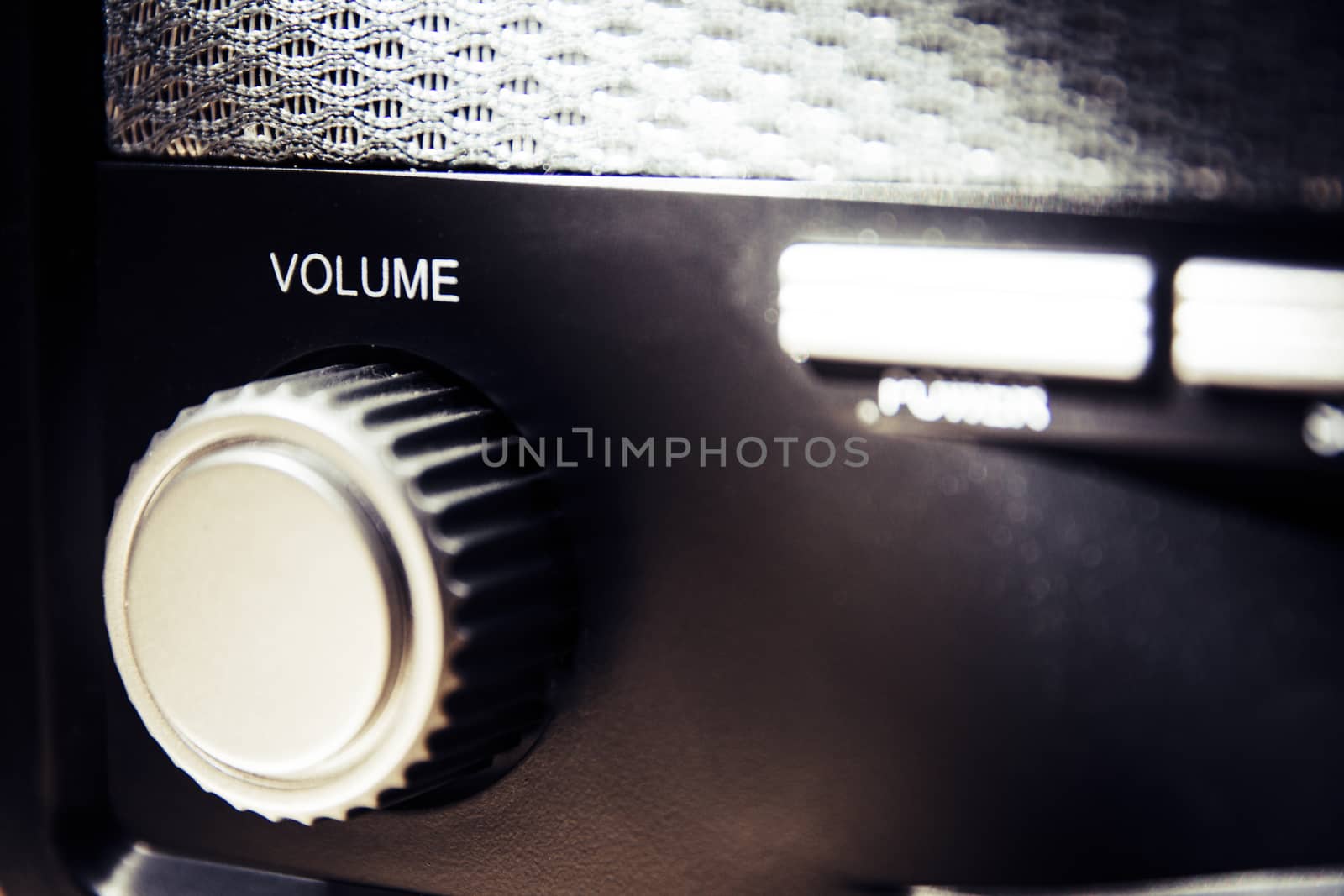 Volume wheel on an old and vintage analog radio. Creative processing for retro looks. Selective focus.