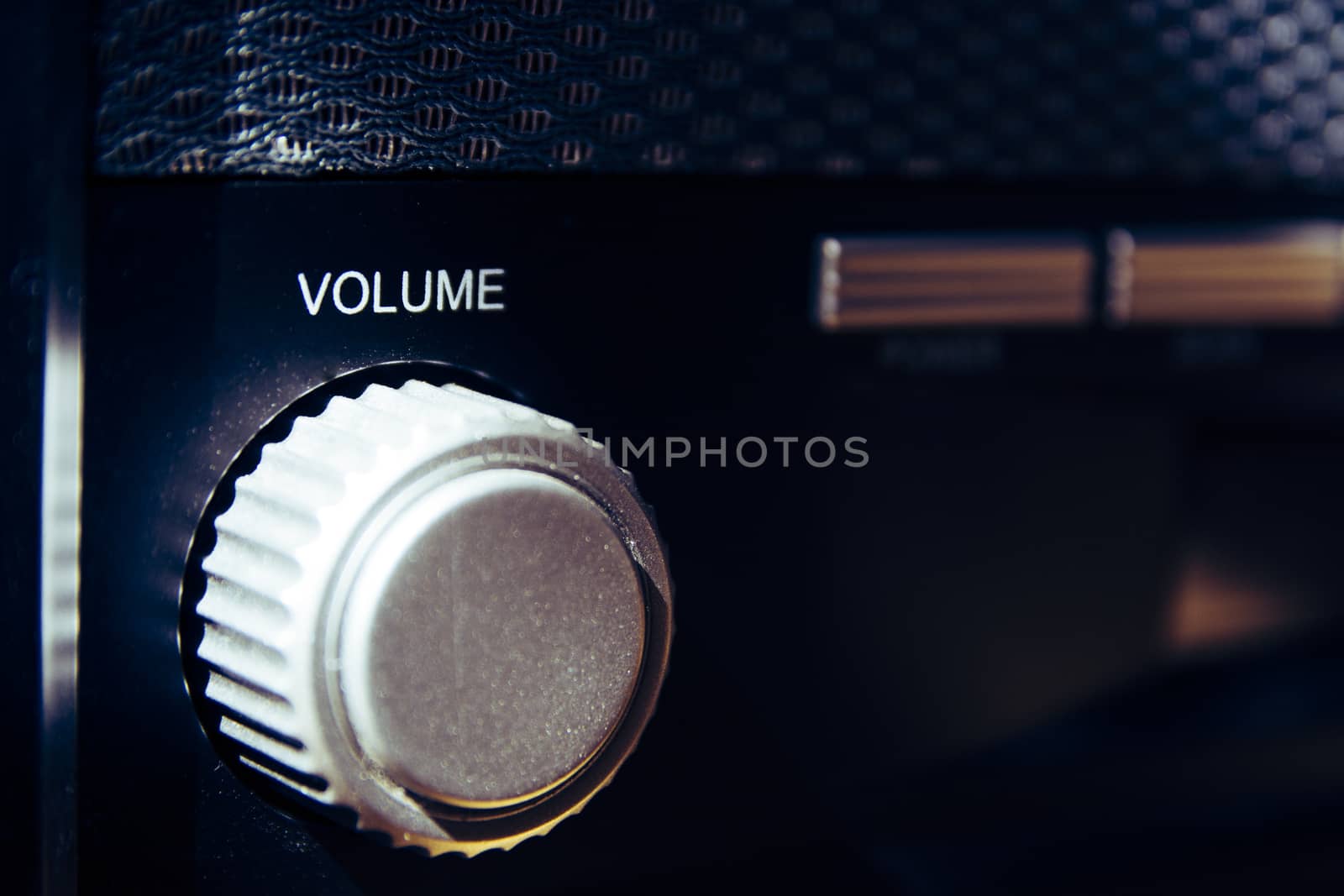 Volume wheel on an old and vintage analog radio. Creative processing for retro looks. Selective focus.