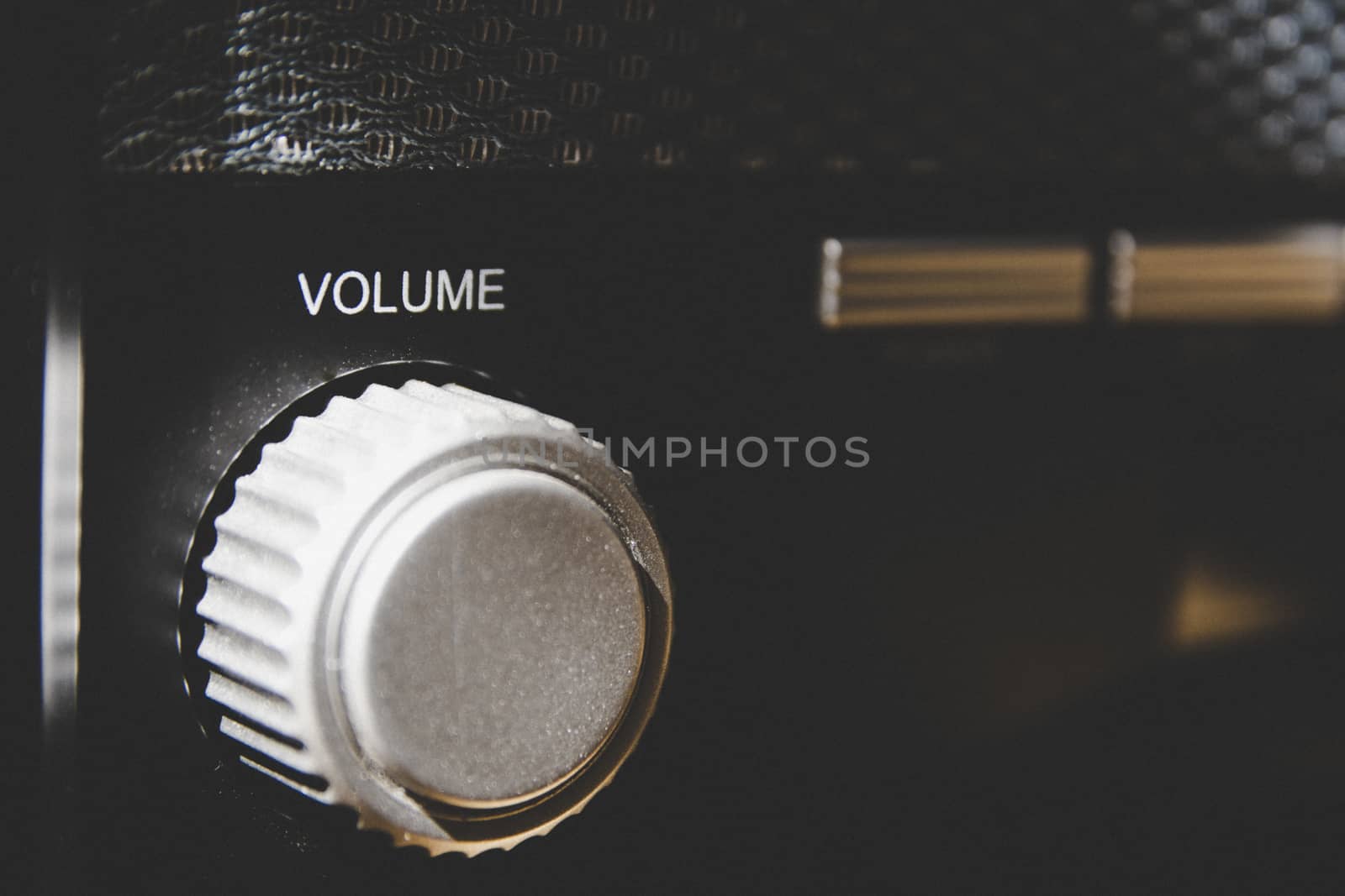 Volume wheel on an old and vintage analog radio. Creative processing for retro looks. Selective focus.