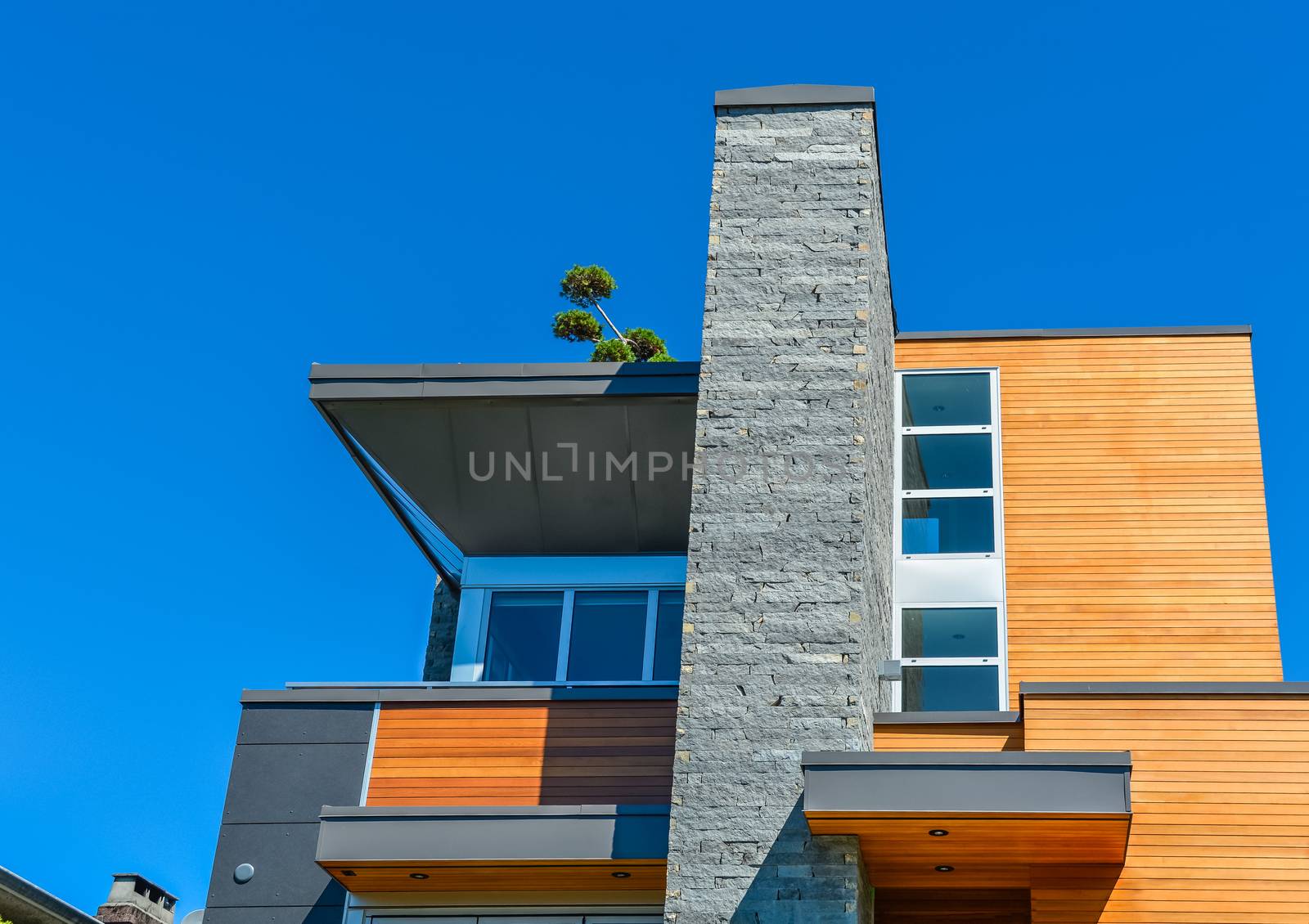 Top of new luxury family house on blue sky background