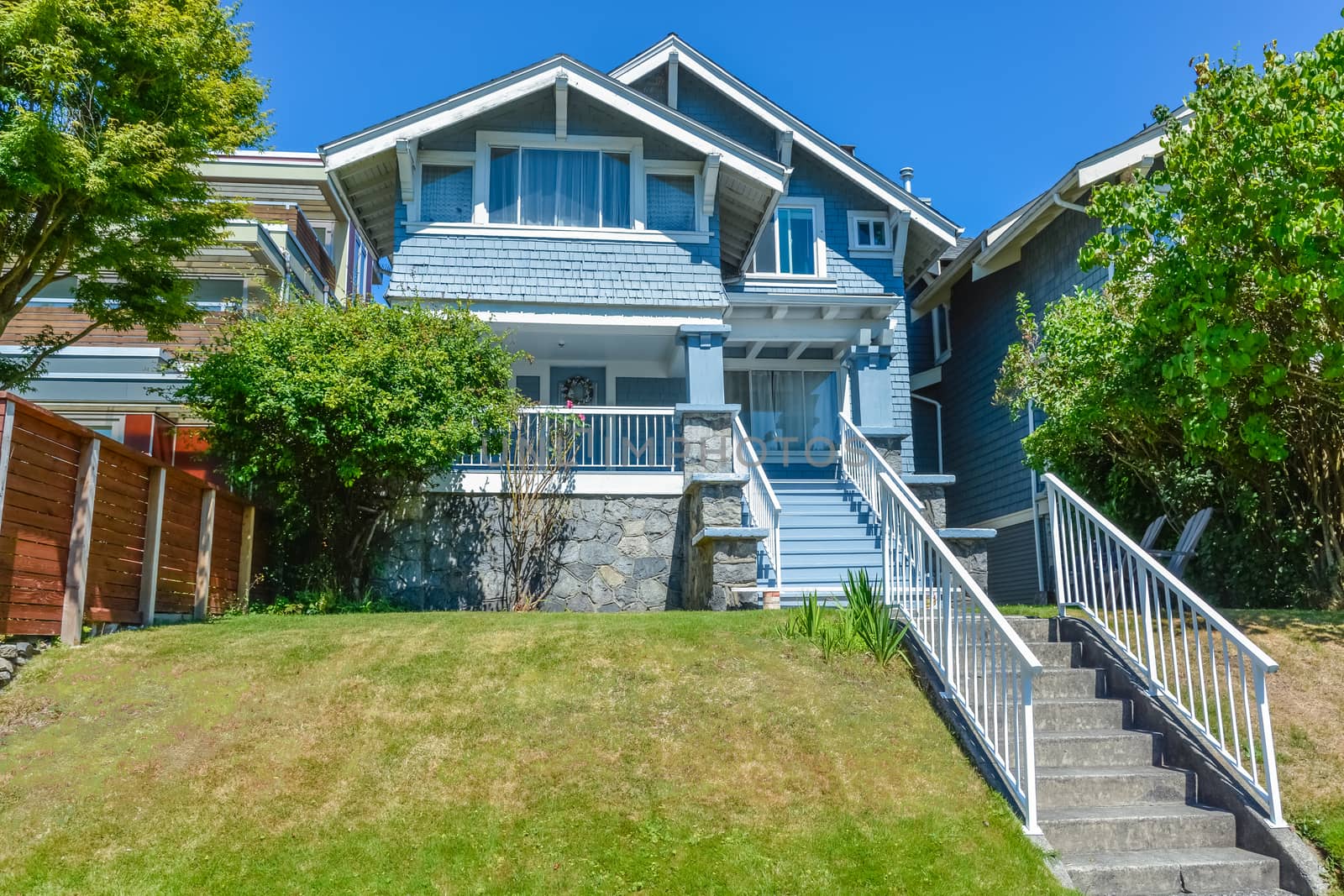 Residential house with concrete stairway over terrace to the entrance