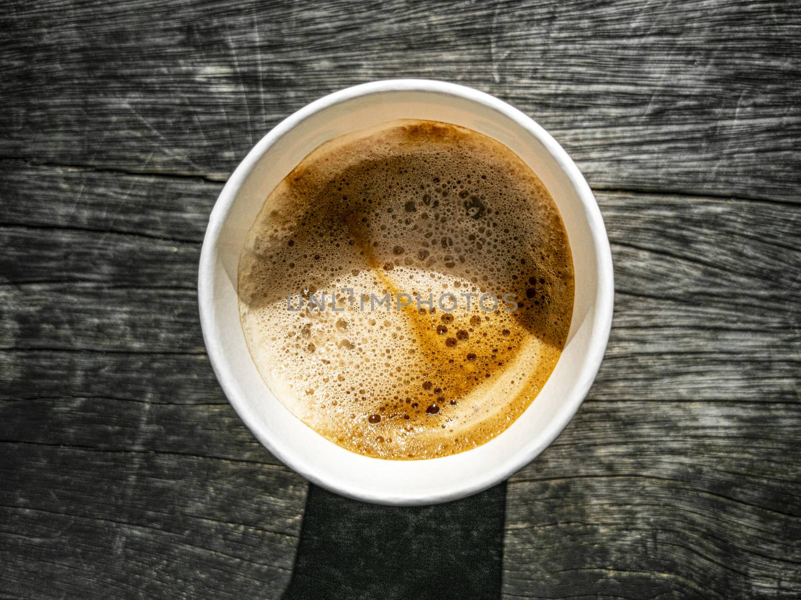 Paper cup coffee to go, wooden ground texture from above. by Arkadij