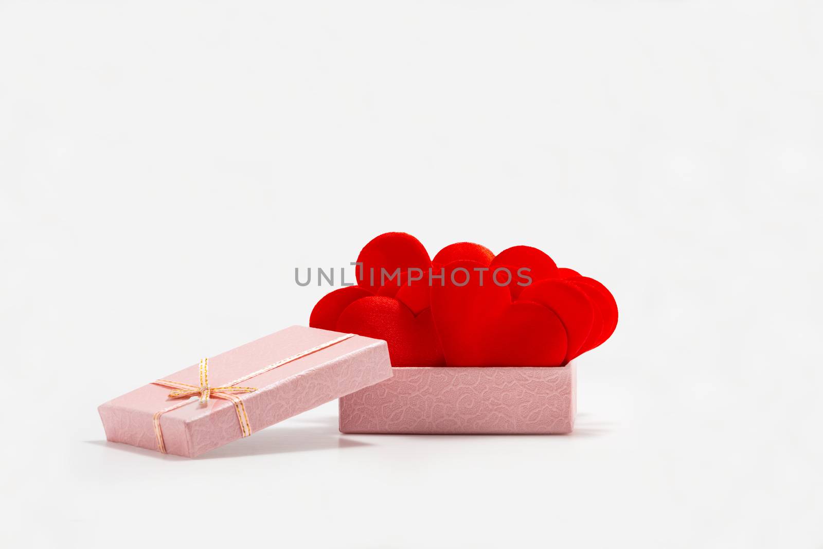 Front View of Red Hearts in a Pink Gift Box. Isolated on White Background. St. Valentines Day. Symbol of Love and Devotion.