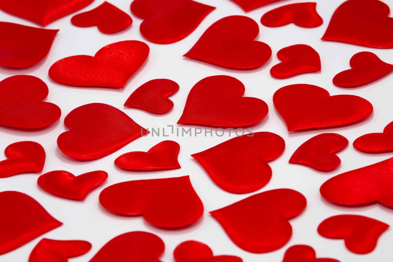 Scattered Red Hearts on White Background. Top view by DamantisZ