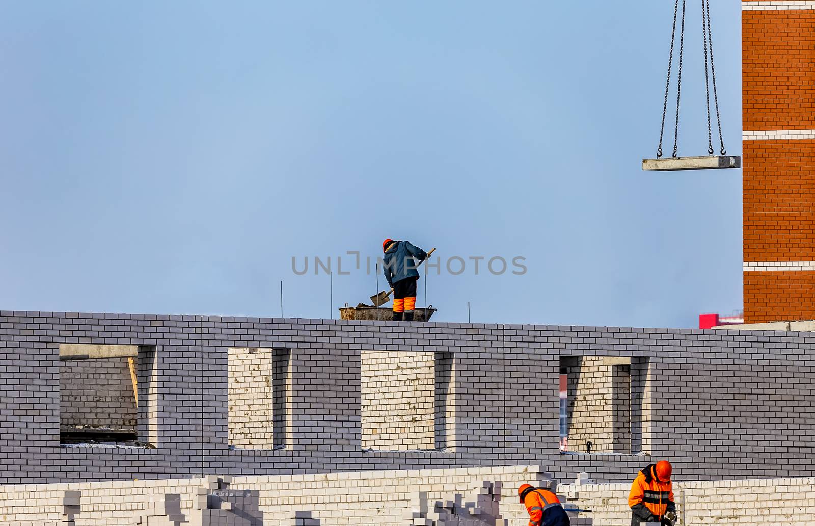 Construction Site. Workers Laying Bricks by DamantisZ