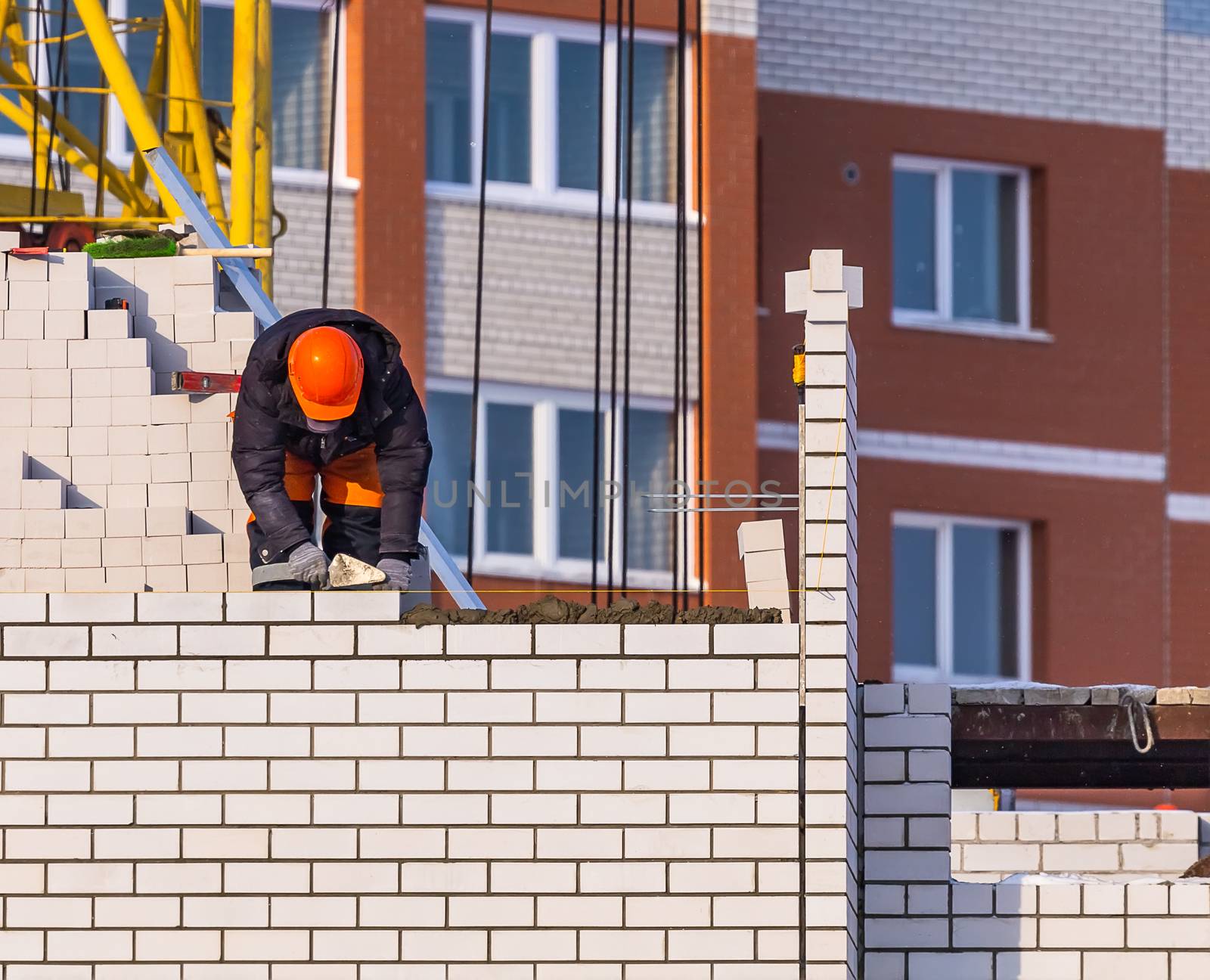 Construction Worker Laying Bricks by DamantisZ