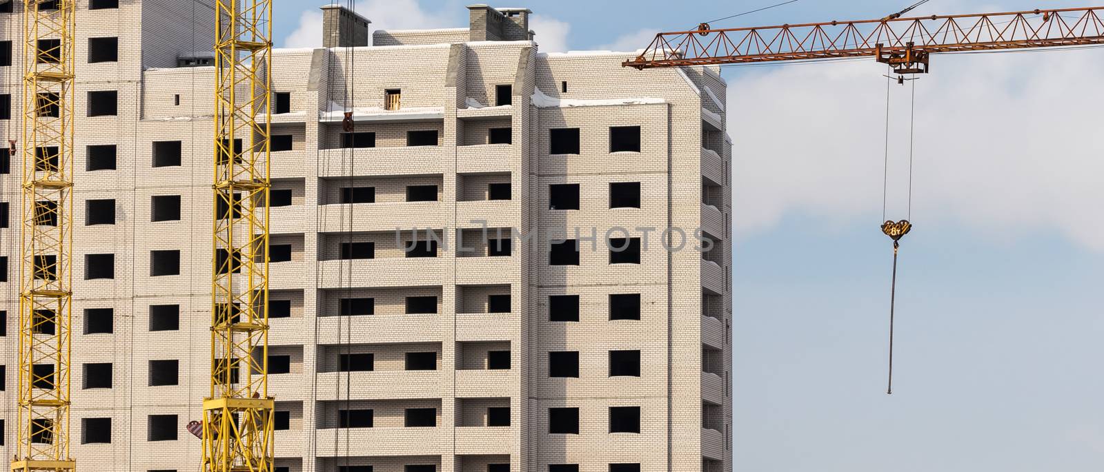 Construction site. Apartment building and cranes by DamantisZ
