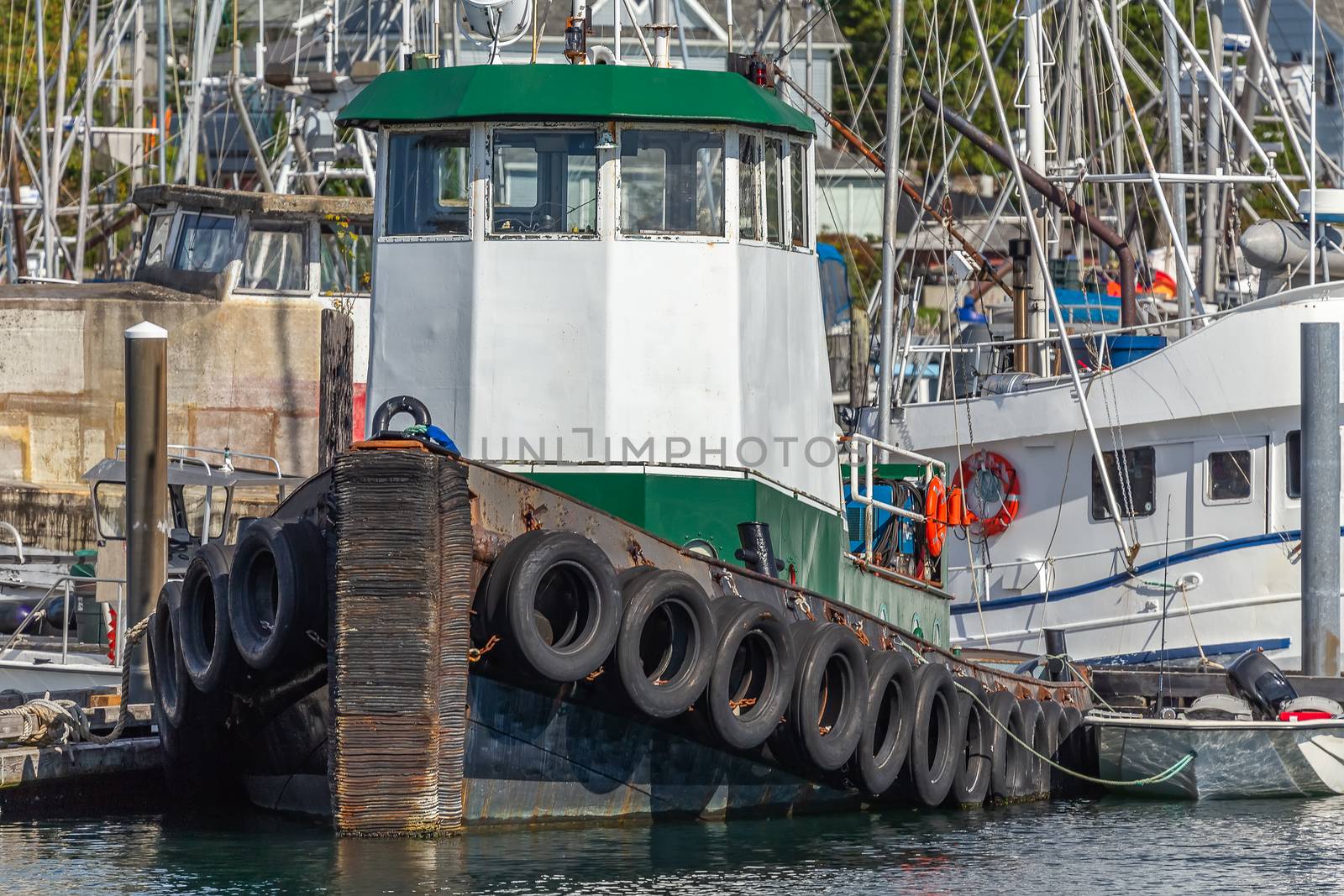 Close view of a tugboat docked in a marina by DamantisZ