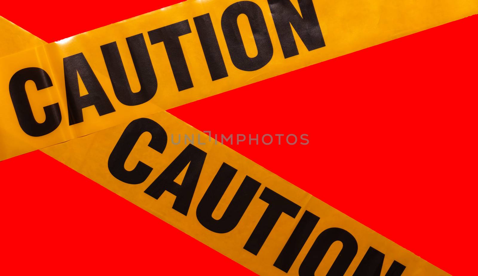 Yellow caution tapes crossing. Isolated. Red background by DamantisZ