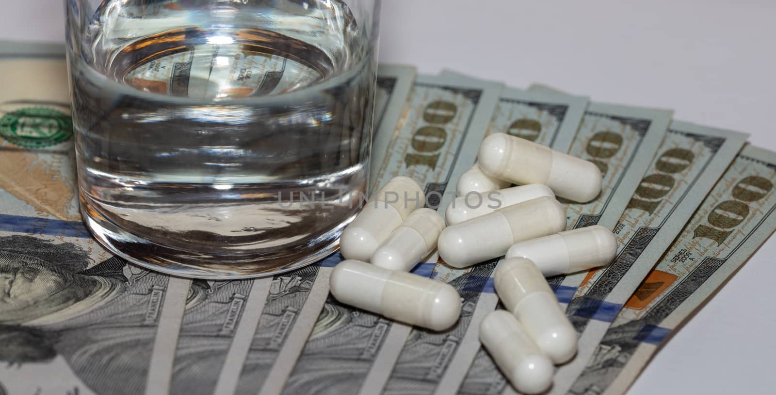 Pills scattered on hundred dollar bills by DamantisZ