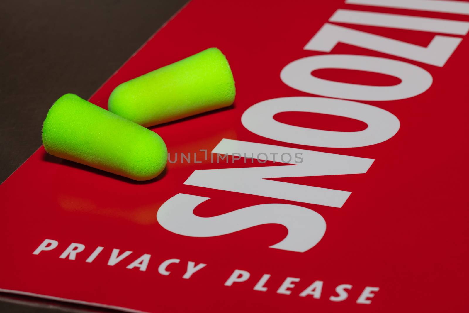 Earplugs on red privacy, snoozing sign. by DamantisZ