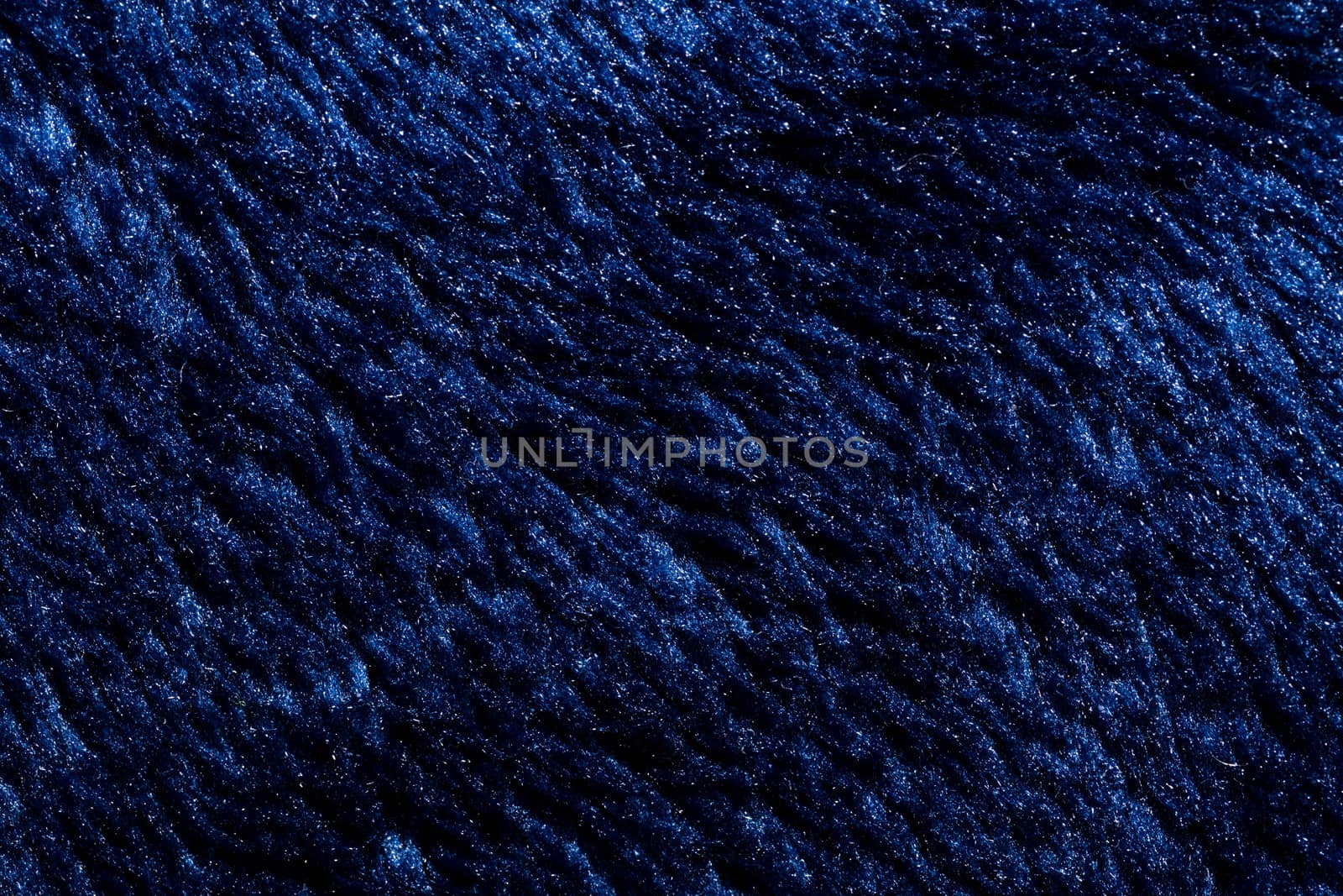 Close-up view of a piece of dark blue fabric. Macro shot. Texture.