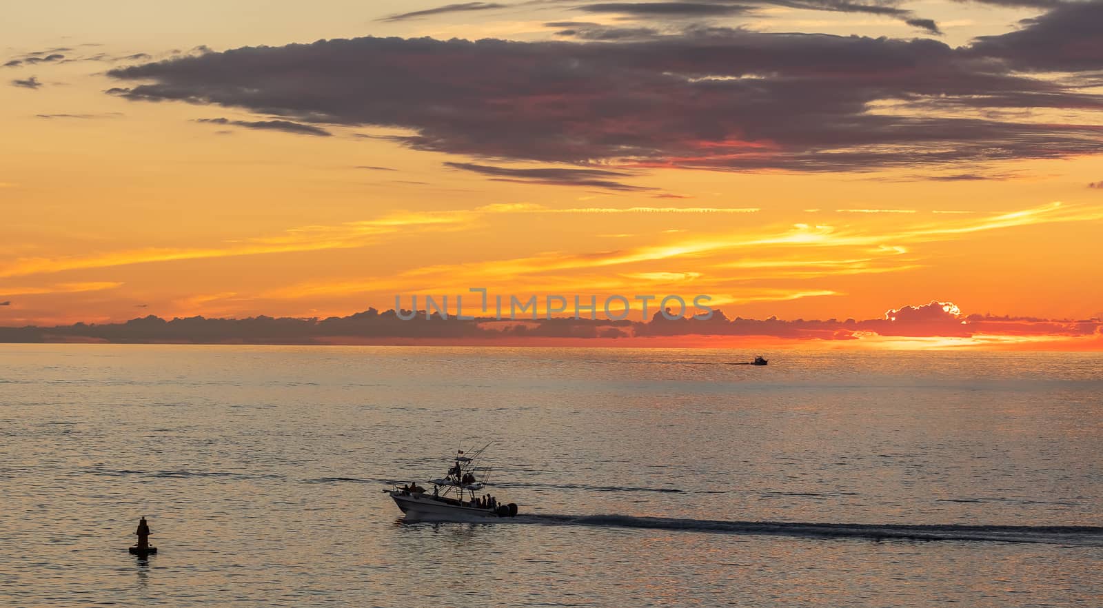 Fishing boat sailing at sunset in Mexico. Beautiful sky by DamantisZ