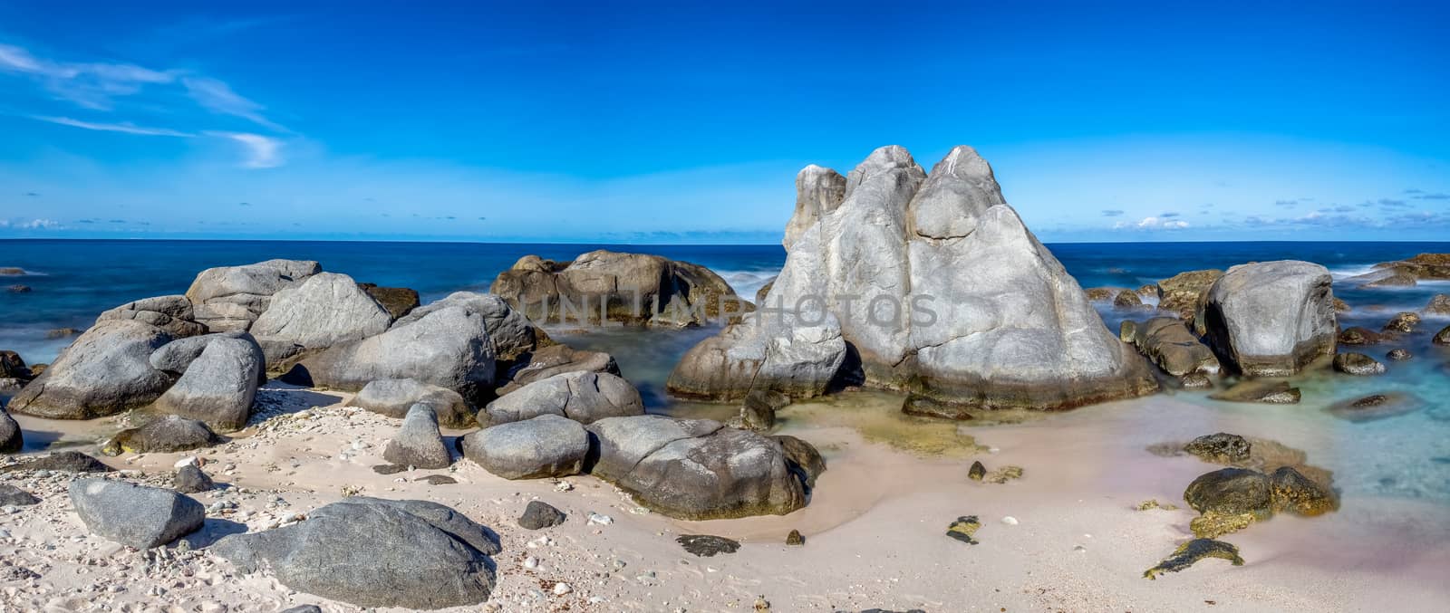 Beautiful panoramic landscape of a rocky beach in Aruba by DamantisZ