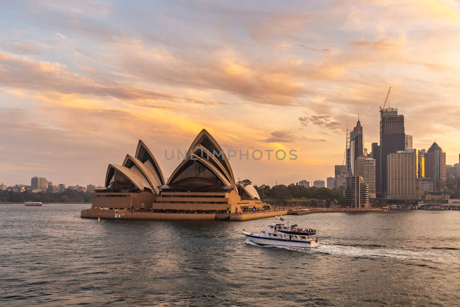 Sydney Opera House at sunset. Boat sailing by it by DamantisZ