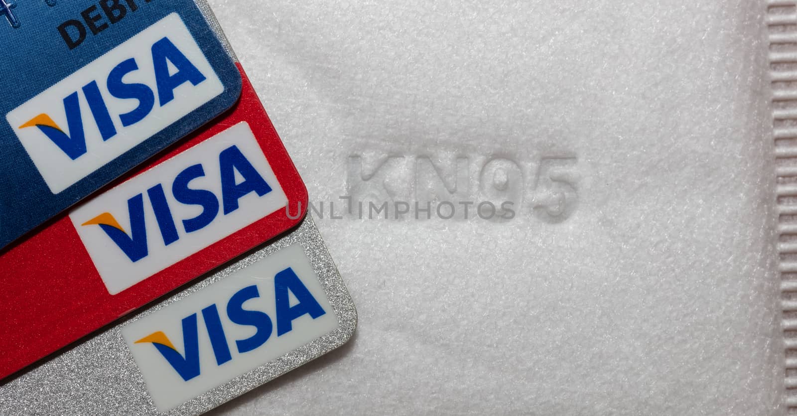 Part of KN95 facial mask and visa debit cards by DamantisZ