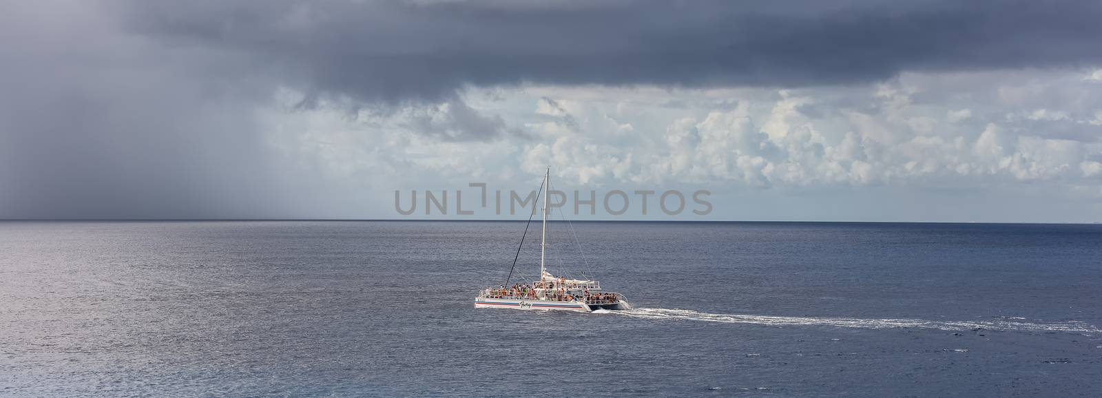 Catamaran Fury sailing by the island of Cozumel by DamantisZ