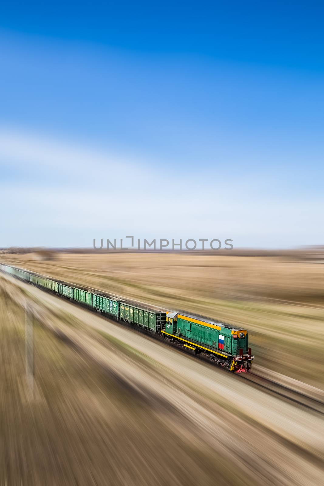Perspective view of a moving train with Russian flag on it