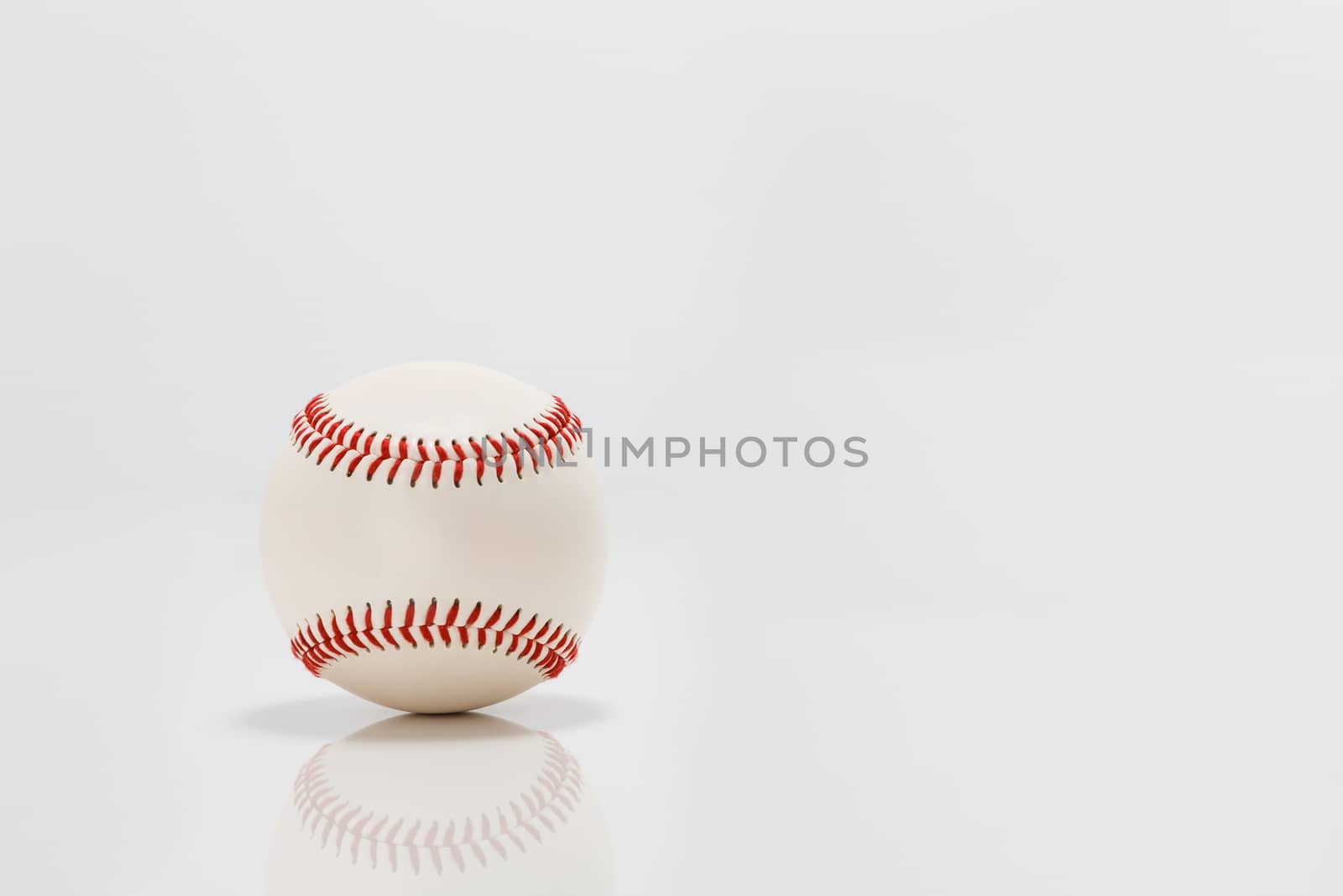 Professional baseball on white background. Isolated and reflecting in the surface below it.