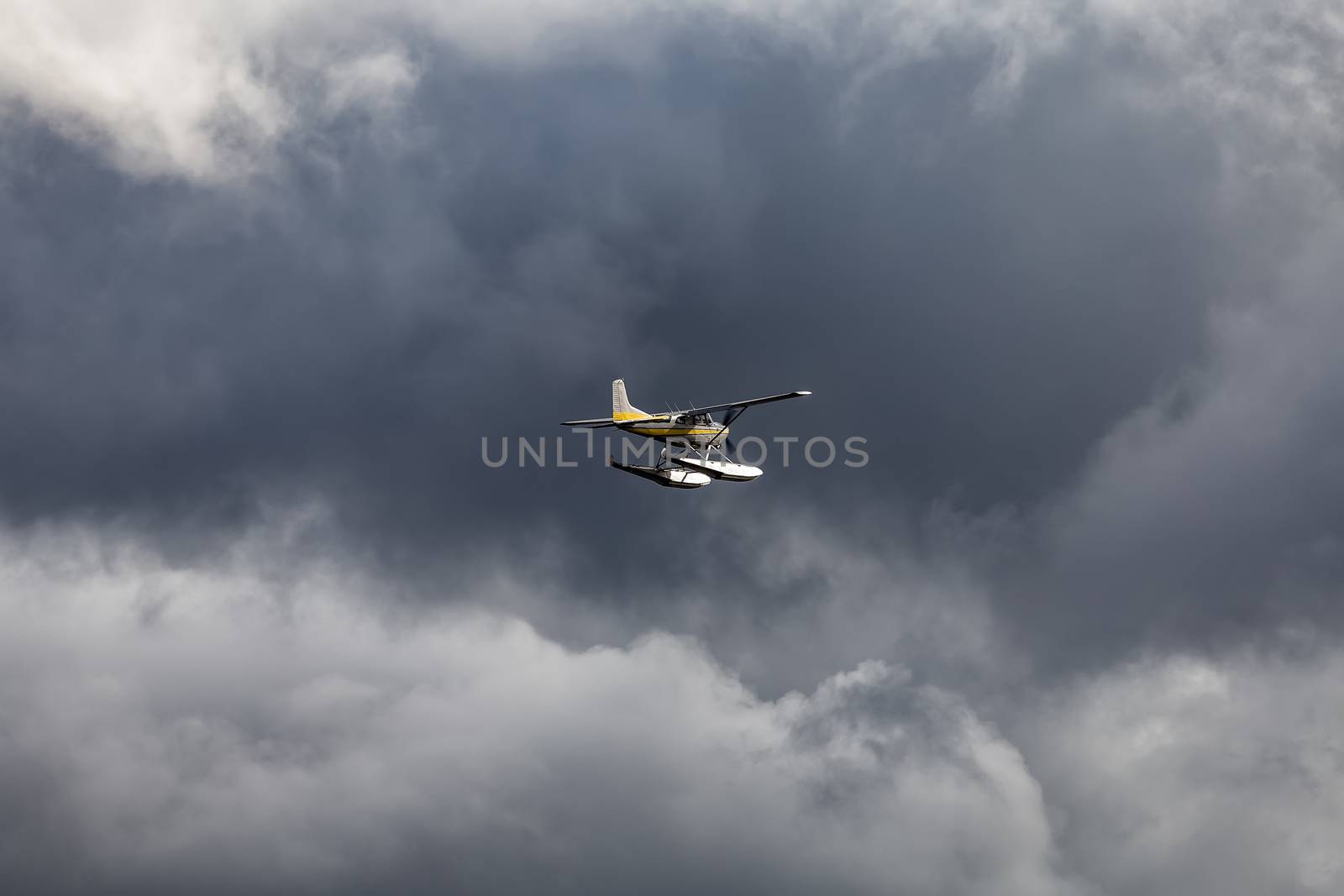 Plane flying towards a storm. Dark clouds as a background.