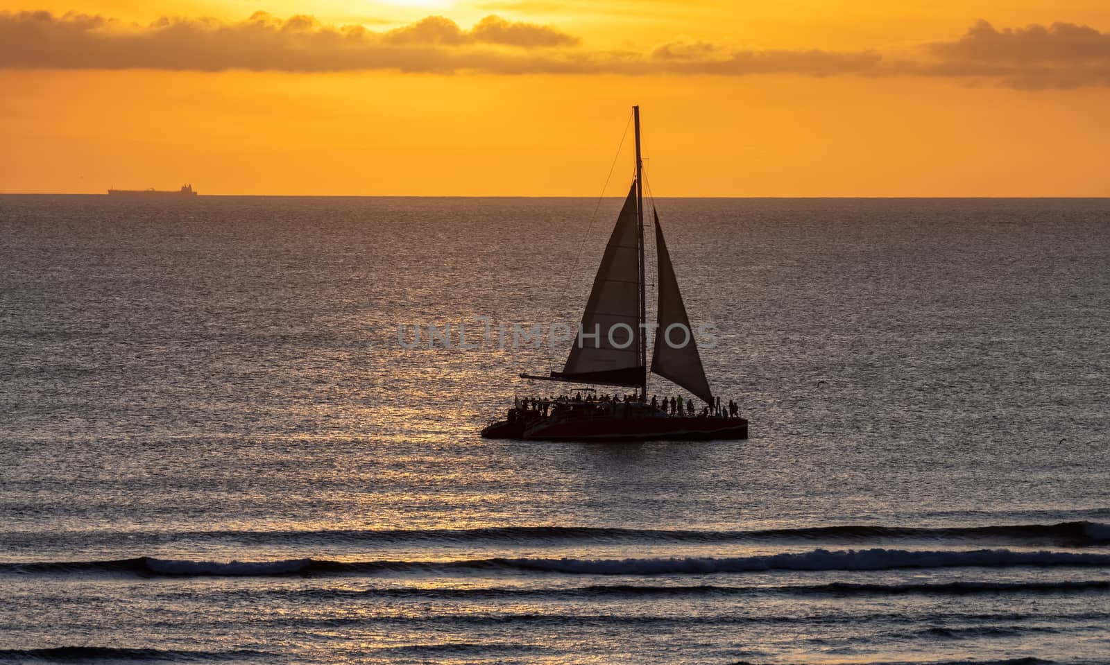 Catamaran at sunset with beautiful orange sky by DamantisZ