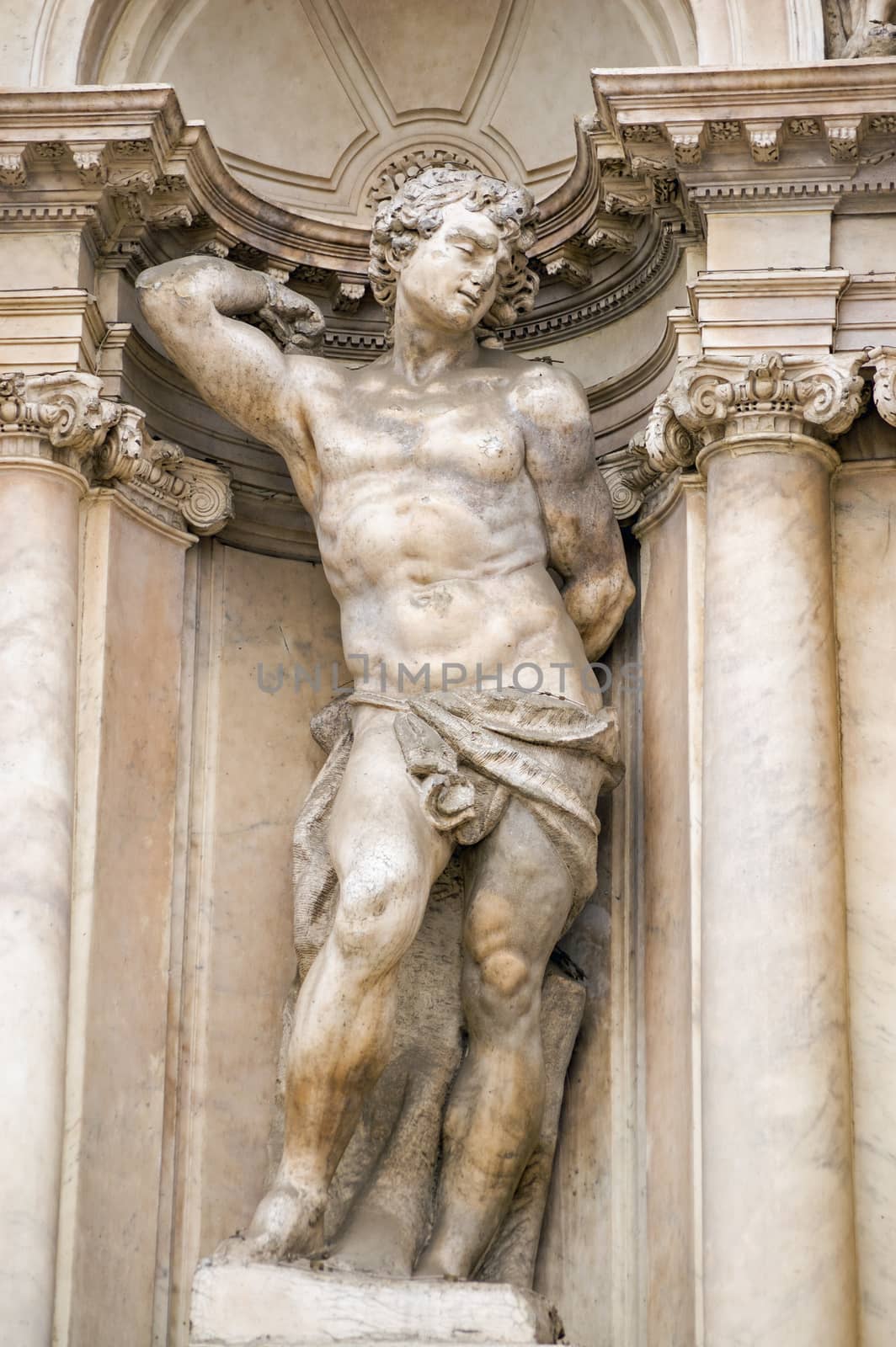 Statue of a male nude representing a human virtue. Facade of the Scalzi church in the Cannaregio district of Venice, Italy.