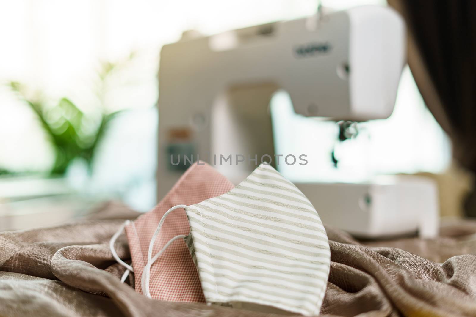 Fabrics and sewing machine for sewing an anti-virus face mask during the coronavirus pandemia.