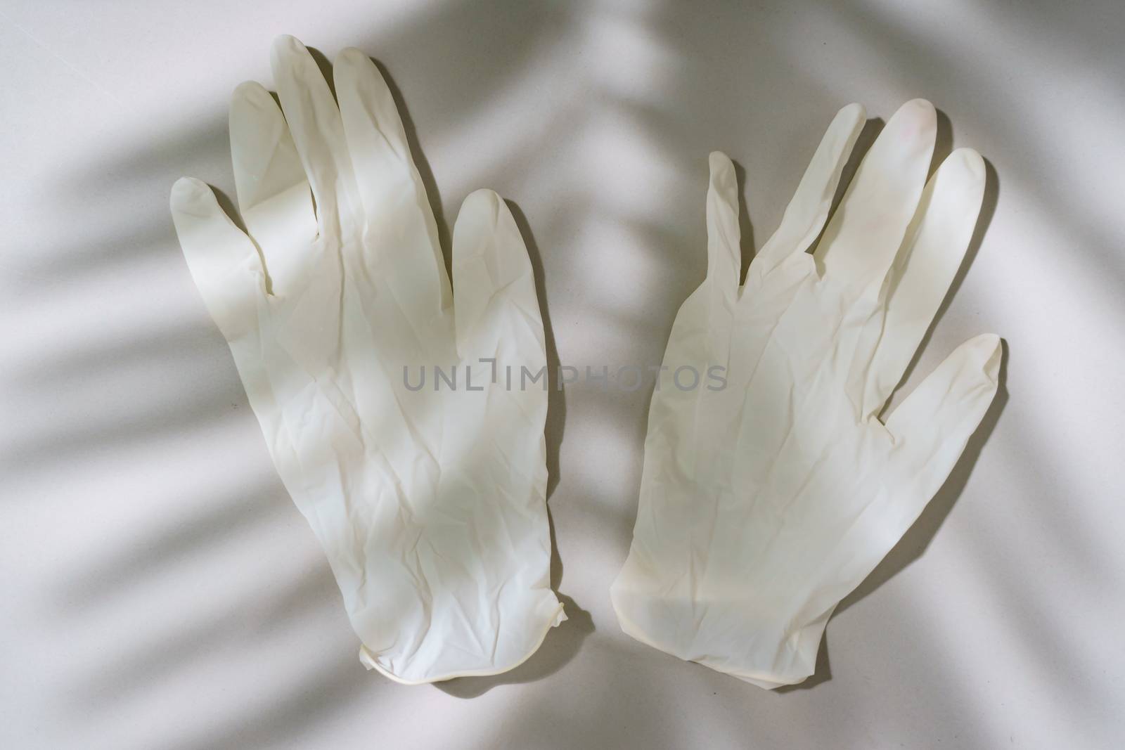 Pair of white latex medical gloves by sirawit99