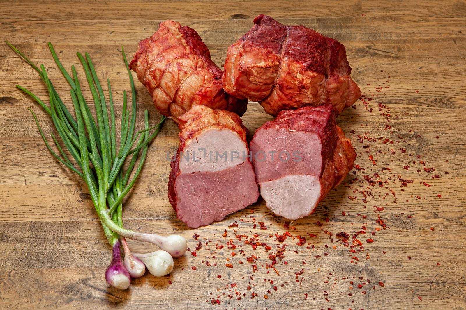 Ham sausage and onions on a wooden desk