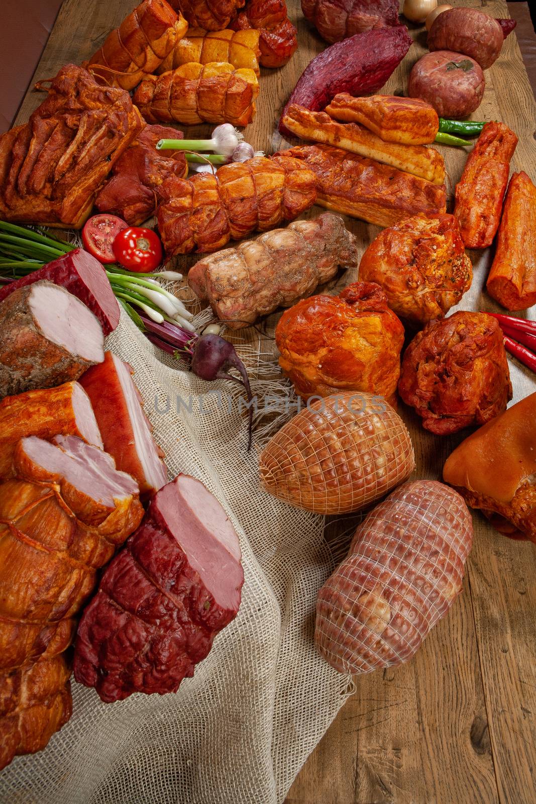 Different kinds of meat and vegetables on a studio background