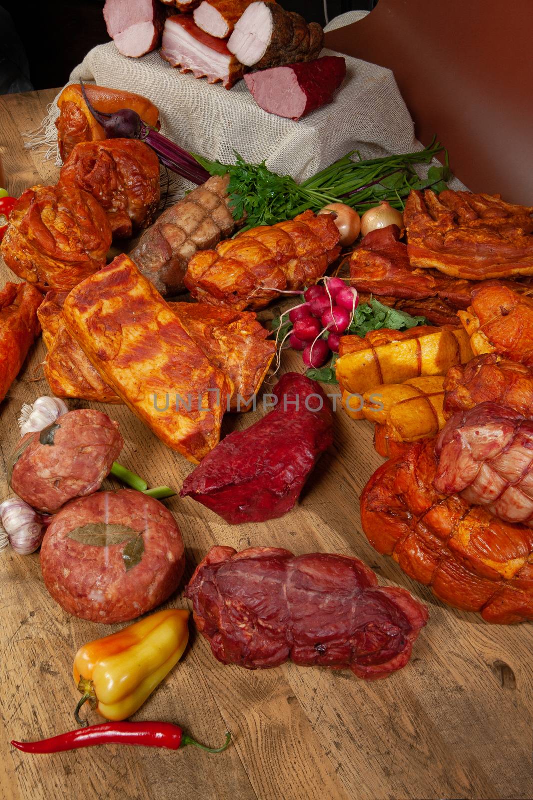 Different kinds of meat and vegetables on a studio background