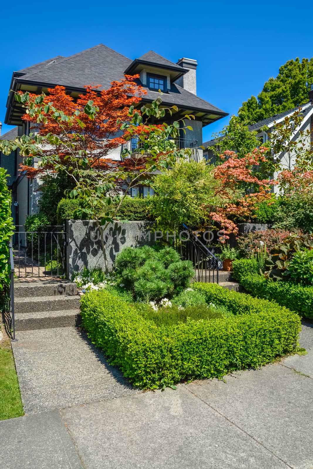 Delicately landscaped front yard of residential house