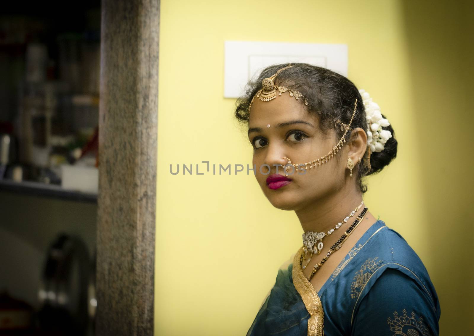 gorgeous south Indian woman with red lipstick on lips, Indoors youth Girl portrait