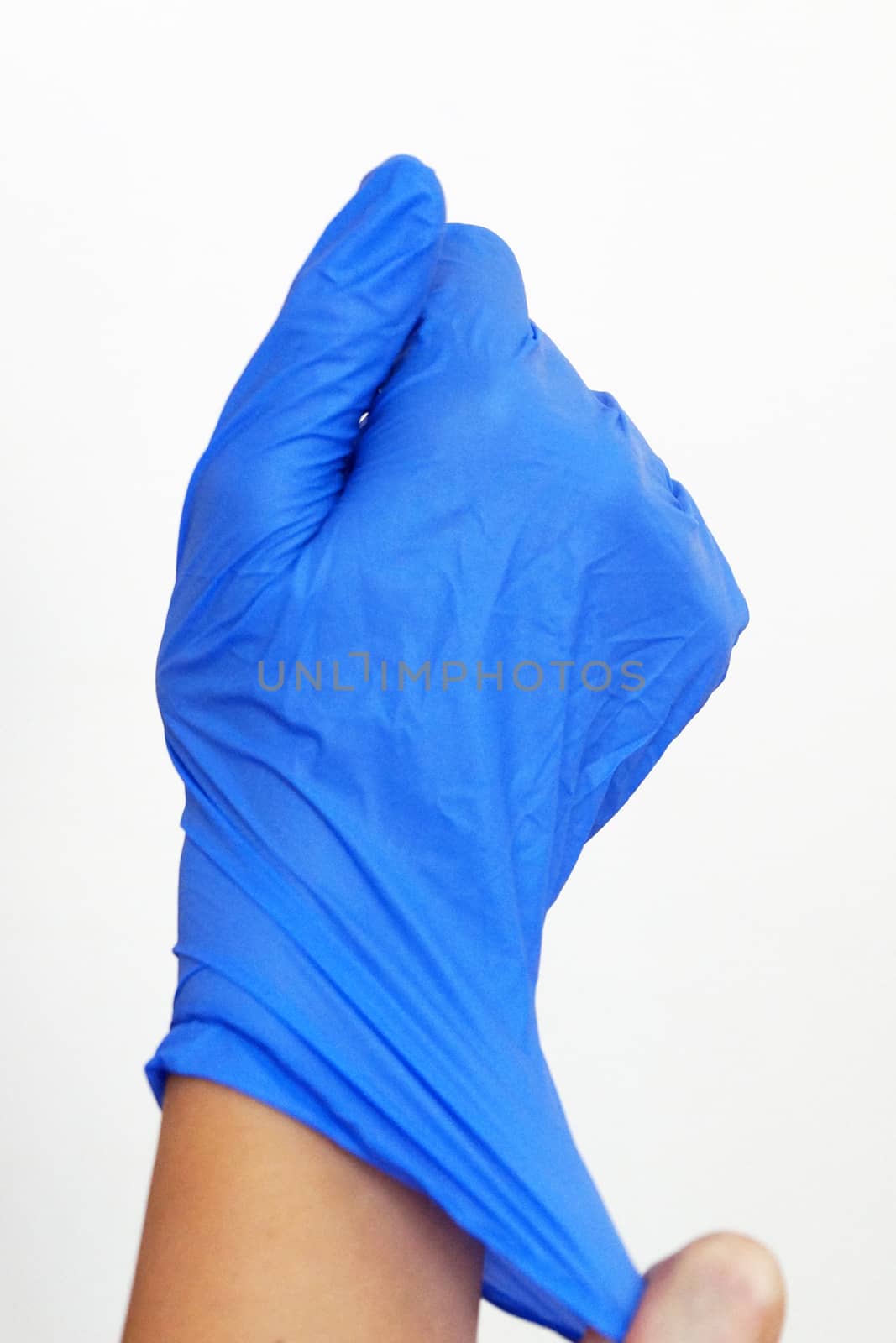 a medical glove is put on a hand close up