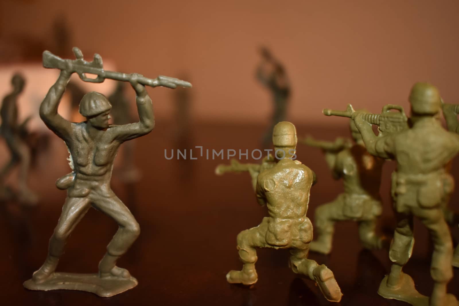 Toy Soldiers Doing Battle on a Wooden Surface by bju12290