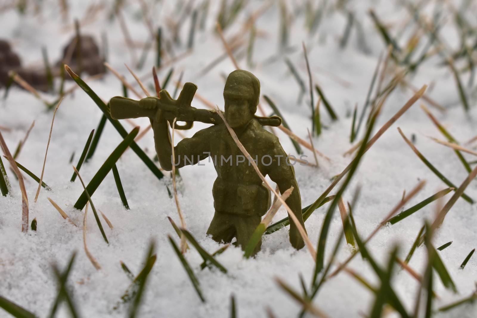 A Toy Soldier Resting His Rifle on His Shoulder in Knee-Deep Snow