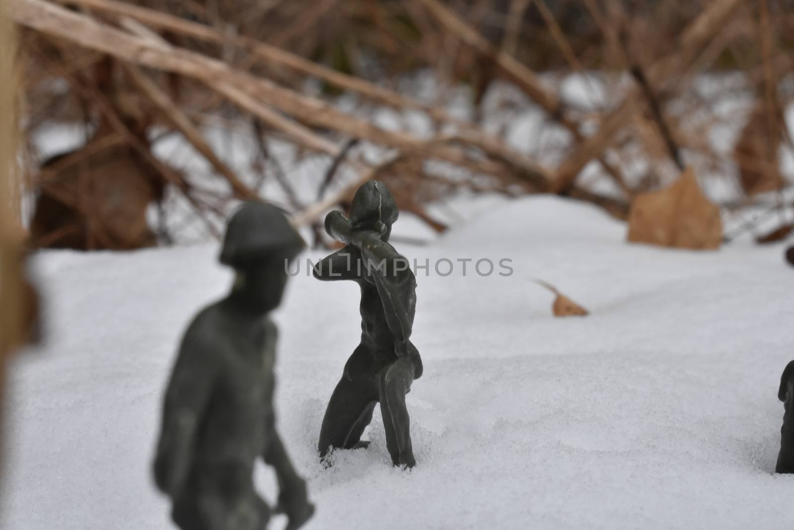 A Toy Soldier Taking Aim and Ready to Fight in Knee-Deep Snow