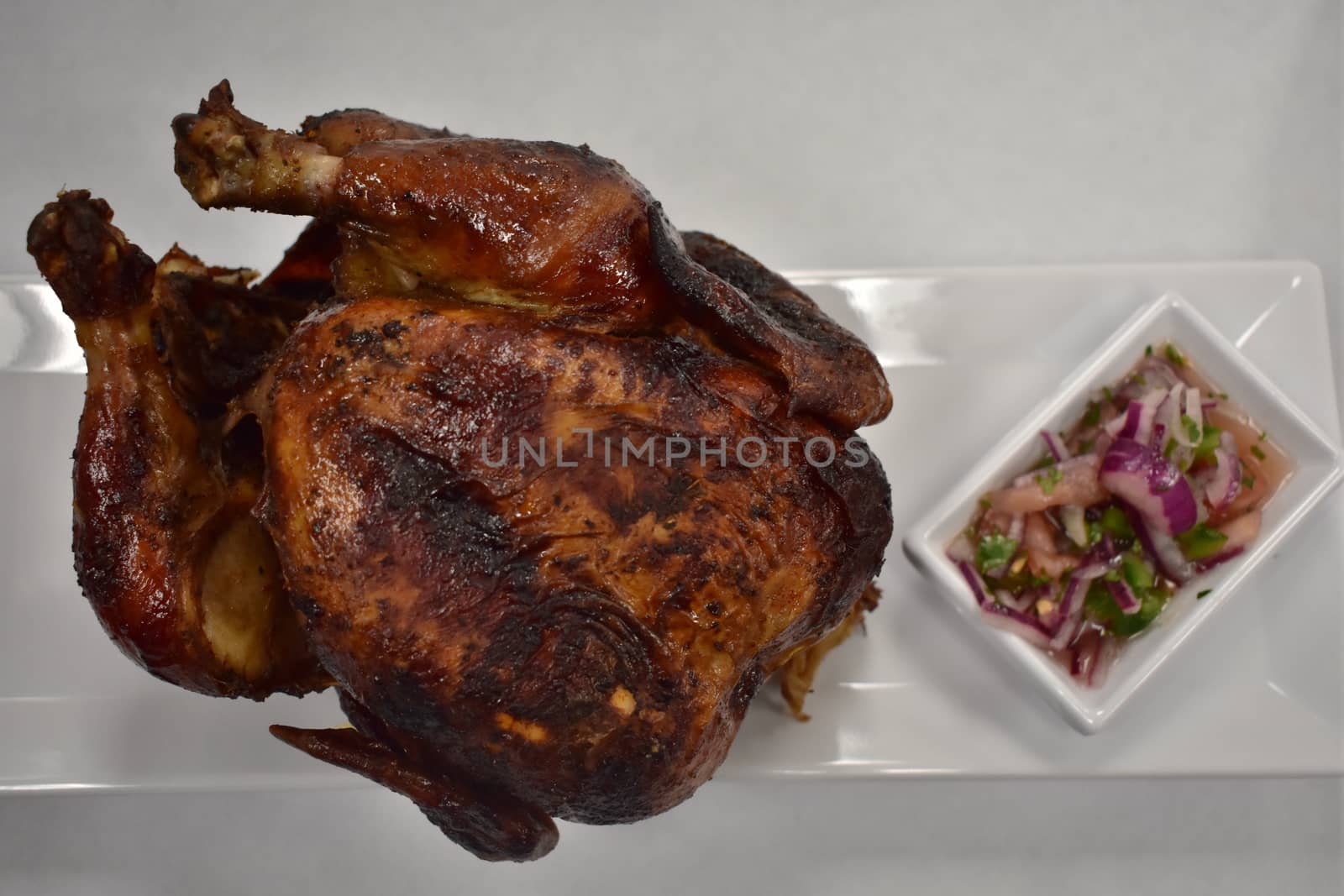 Rotisserie Chicken on a Plate With Potatoes and a Salad by bju12290