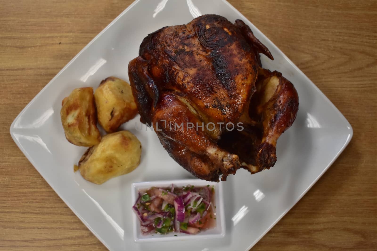 Rotisserie Chicken on a Plate With Potatoes and a Salad by bju12290