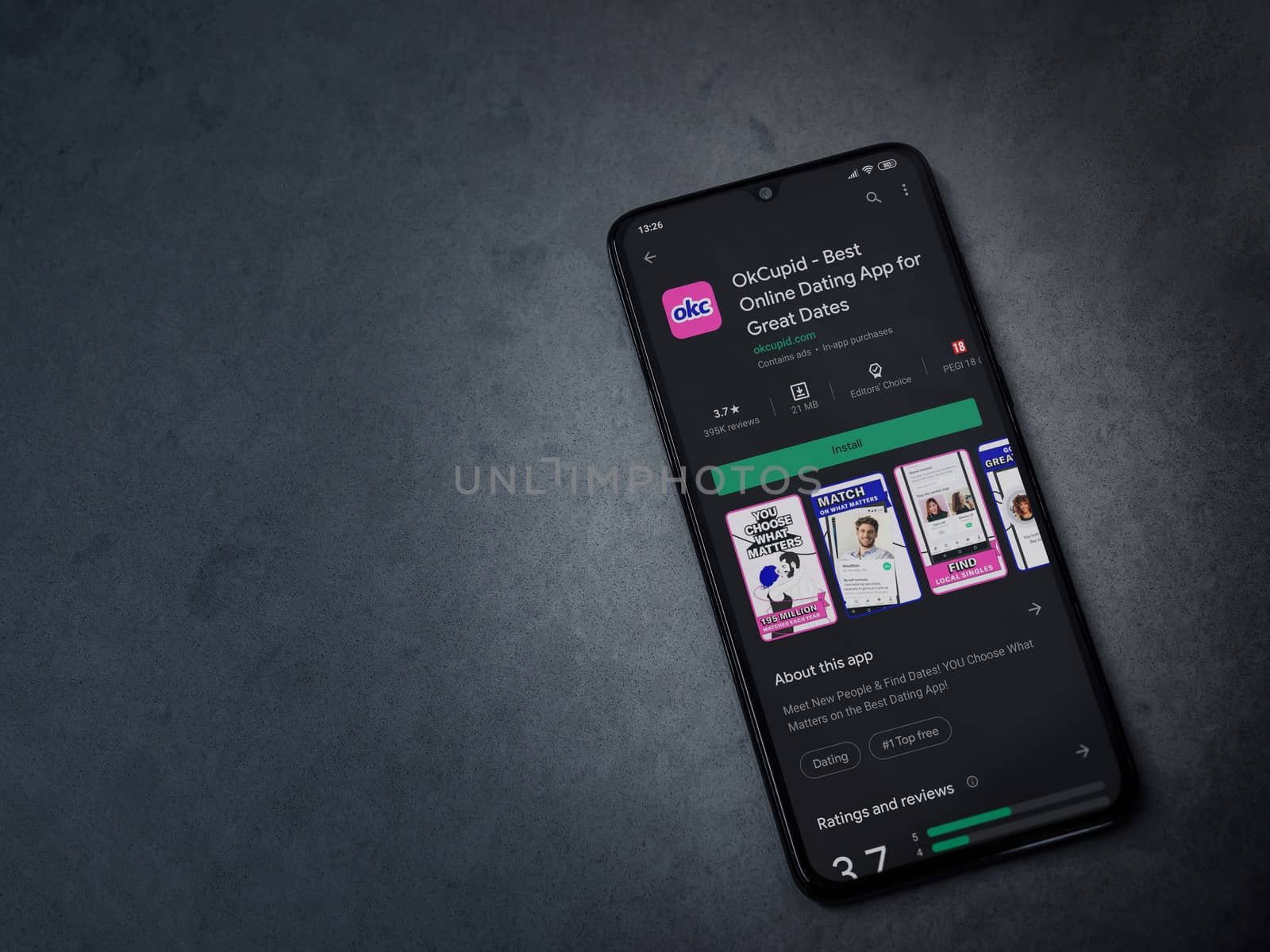 OkCupid app play store page on the display of a black mobile sma by wavemovies