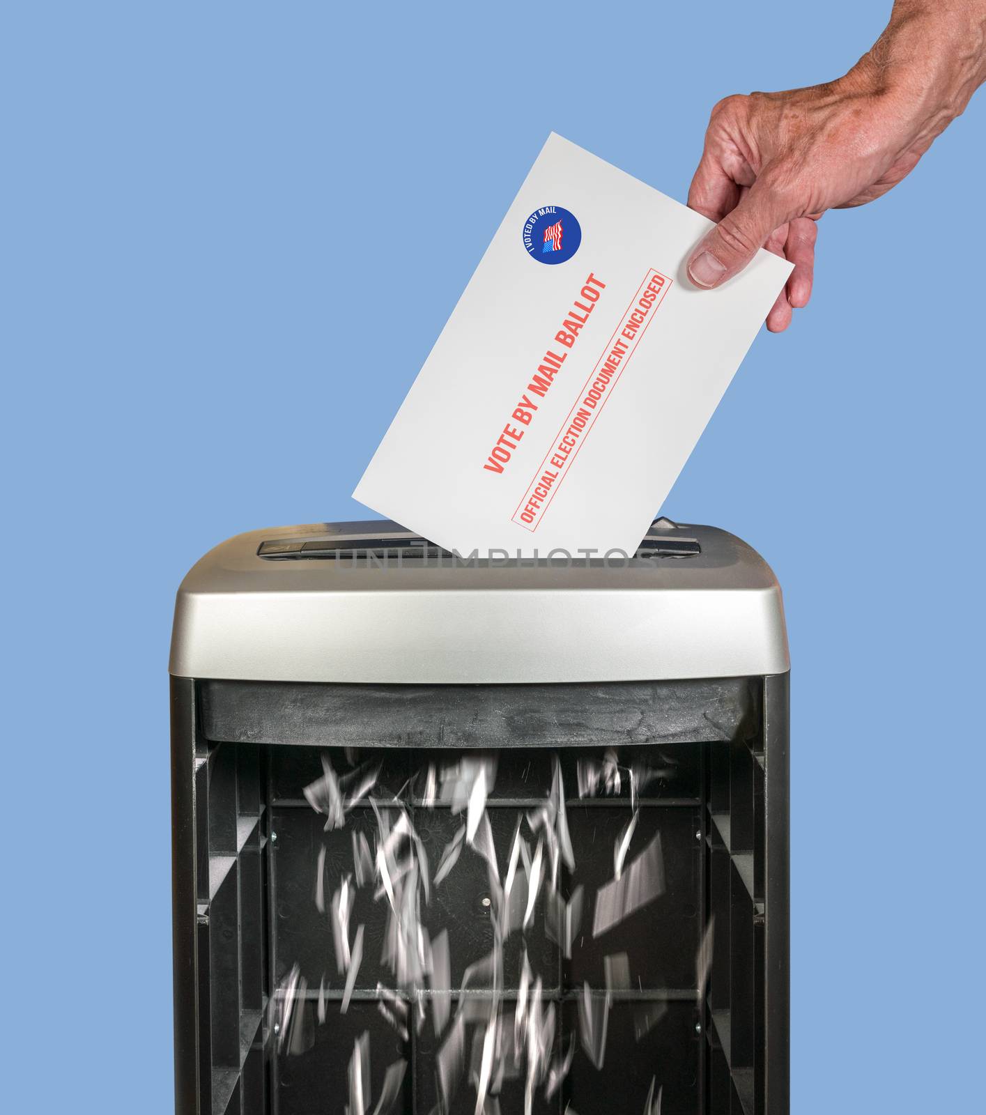 Vote by mail or absentee ballot being shredded in office paper shredder as illustration of voting fraud or lost votes in Presidential election