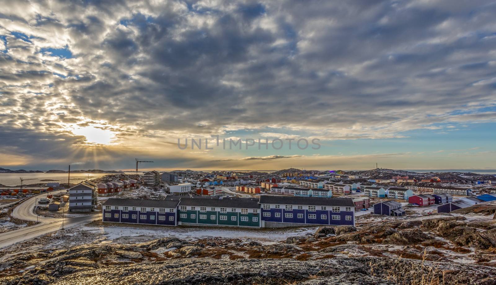 Grenlandic arctic city panorama with houses on the rocky hills in sunset city panorama. Nuuk, Greenland