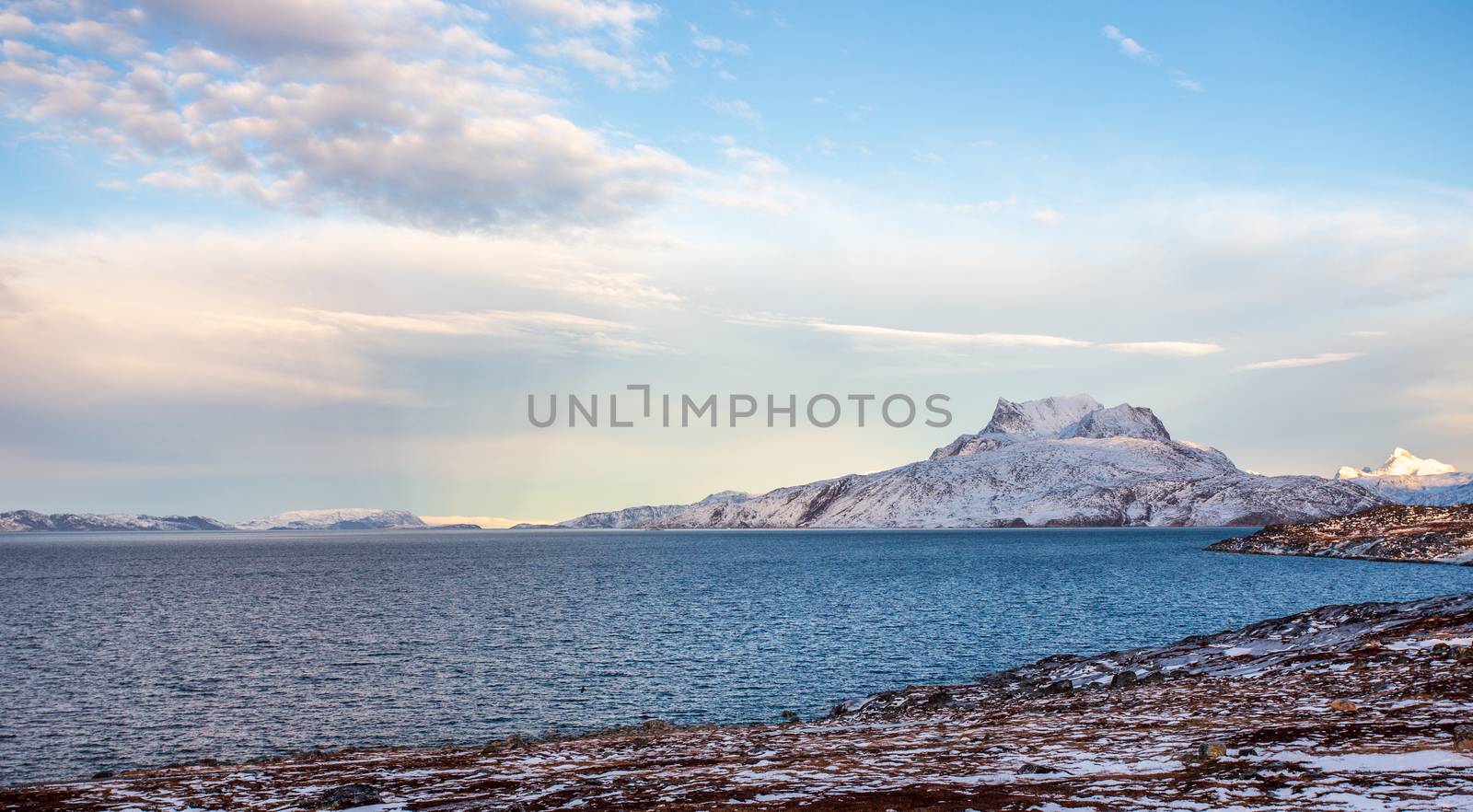 Frozen tundra landscape with cold greenlandic sea and snow Sermi by ambeon