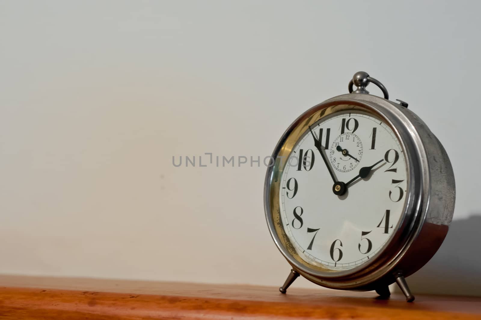 Classic vintage golden clock on a table with copyspace