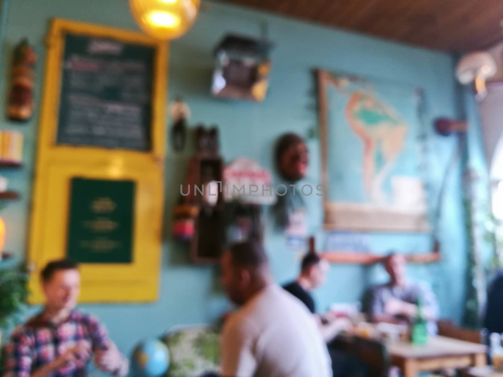 Blurry defocused scene of people in cosy local cafe in Latin Ame by eyeofpaul