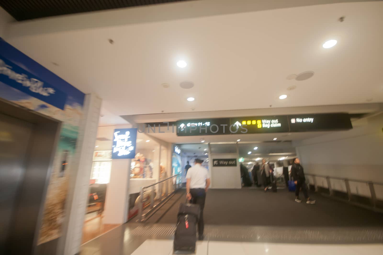 Blurry scene of rushing to follow a flight captain to pass the scanner gate in the airport