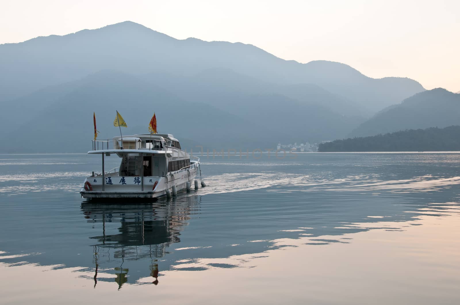 Tourist boat sailing in early morning Sun Moon Lake by eyeofpaul