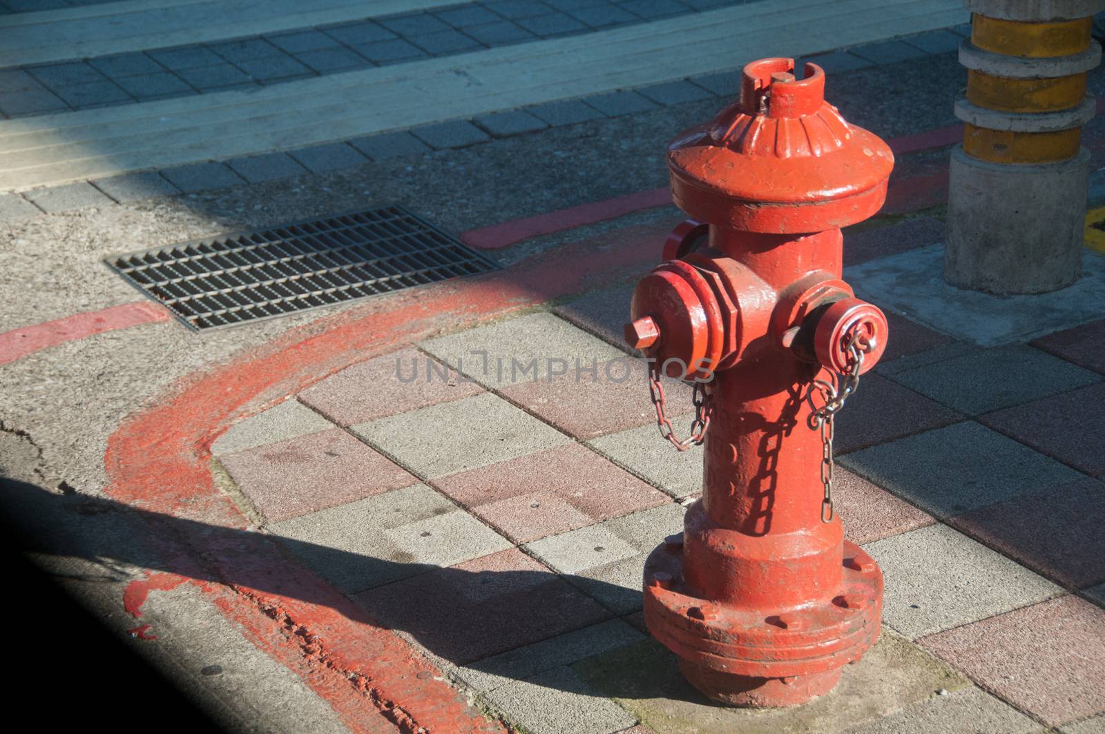 Red firefighter water pipe in city